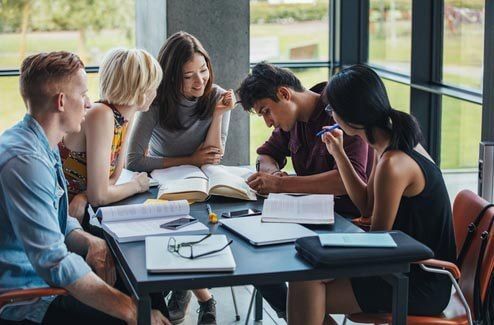 Group of leaders discussing financial scenarios during the academy